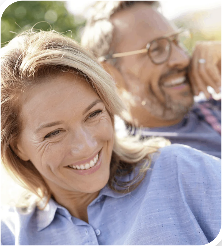 Smiling couple embracing in a bright, comfortable space
